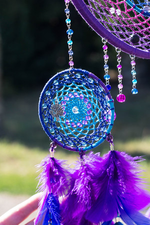 photo of a dreamcatcher made by hand, with using threads, beads and feathers roosterの写真素材