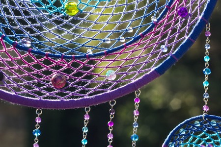 photo of a dreamcatcher made by hand, with using threads, beads and feathers roosterの写真素材