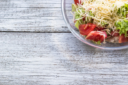 Caesar salad with chicken on the wood backgroundの写真素材