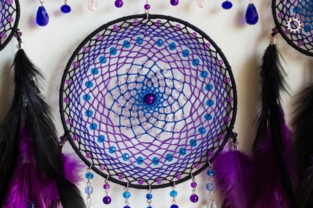 photo of a dreamcatcher made by hand, with using threads, beads and feathers roosterの写真素材