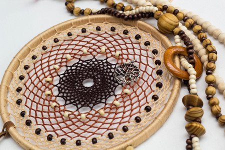 photo of a dreamcatcher made by hand, with using threads, beads and feathers roosterの写真素材