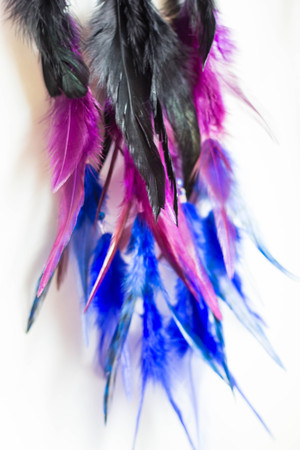 photo of a dreamcatcher made by hand, with using threads, beads and feathers roosterの写真素材