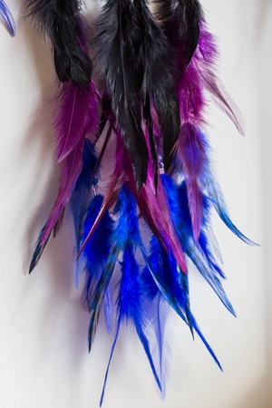 photo of a dreamcatcher made by hand, with using threads, beads and feathers roosterの写真素材