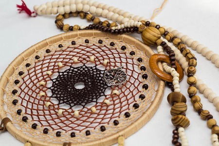 photo of a dreamcatcher made by hand, with using threads, beads and feathers roosterの写真素材