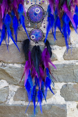 photo of a dreamcatcher made by hand, with using threads, beads and feathers roosterの写真素材