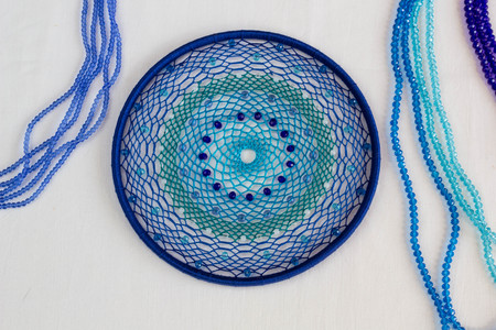 set for making a Dreamcatcher, beads, thread on a white backgroundの写真素材