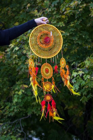 Dreamcatcher made of feathers leather beads and ropes, hangingの写真素材