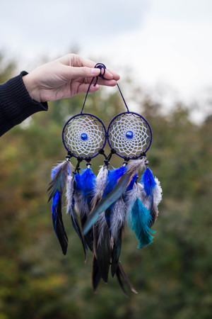 Dreamcatcher made of feathers leather beads and ropes, hangingの写真素材
