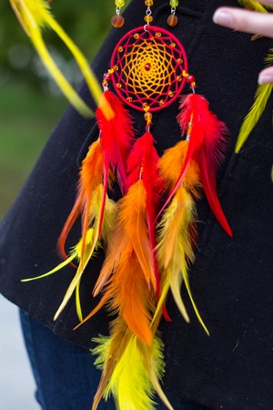 photo of a dreamcatcher made by hand, with using threads, beads and feathers roosterの写真素材