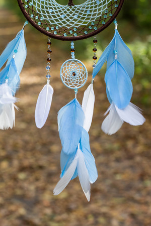 photo of a dreamcatcher made by hand, with using threads, beads and feathers roosterの写真素材