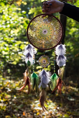 Dreamcatcher made of feathers leather beads and ropes, hanging
