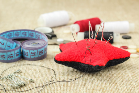 pin cushion with needles,thread and buttons for sewingの写真素材