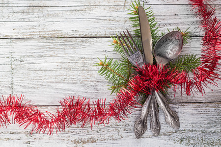 Christmas empty wooden table with knife, fork and spoonの写真素材