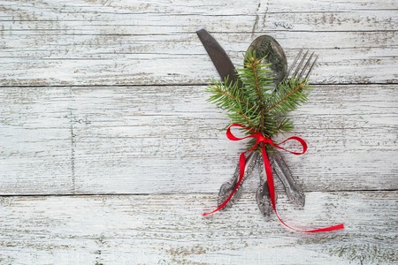 Christmas empty wooden table with knife, fork and spoonの写真素材