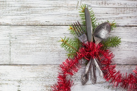 Christmas empty wooden table with knife, fork and spoonの写真素材