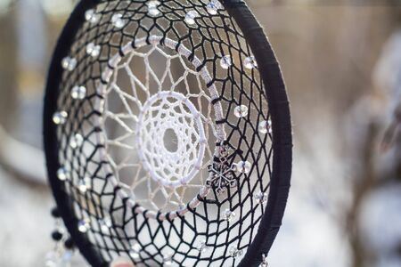 Red black and purple Dreamcatcher with bat made of feathers leather beads and ropes, hangingの写真素材