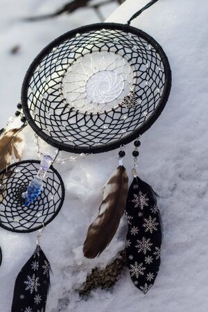 Red black and purple Dreamcatcher with bat made of feathers leather beads and ropes, hangingの写真素材