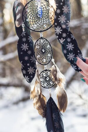 Red black and purple Dreamcatcher with bat made of feathers leather beads and ropes, hangingの写真素材