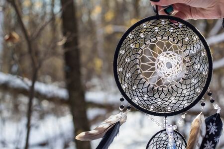 Red black and purple Dreamcatcher with bat made of feathers leather beads and ropes, hangingの写真素材