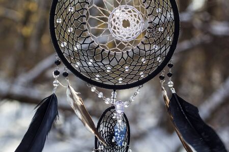 Red black and purple Dreamcatcher with bat made of feathers leather beads and ropes, hangingの写真素材