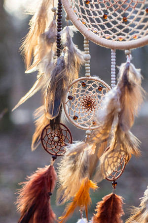 Red black and purple Dreamcatcher with bat made of feathers leather beads and ropes, hangingの写真素材