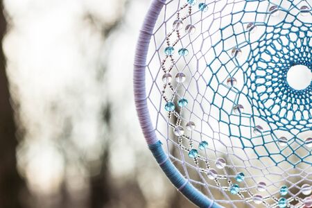 Red black and purple Dreamcatcher with bat made of feathers leather beads and ropes, hangingの写真素材