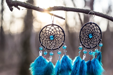 Red black and purple Dreamcatcher with bat made of feathers leather beads and ropes, hangingの写真素材