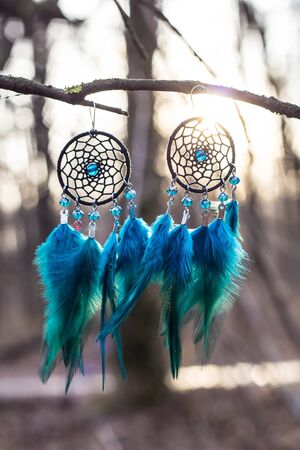 Red black and purple Dreamcatcher with bat made of feathers leather beads and ropes, hangingの写真素材