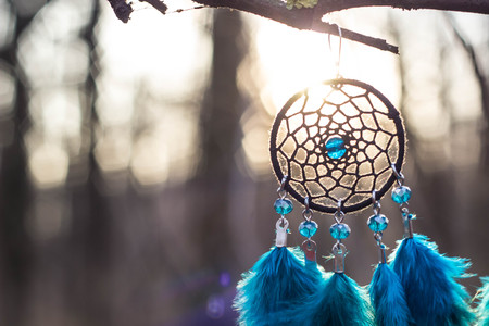Red black and purple Dreamcatcher with bat made of feathers leather beads and ropes, hangingの写真素材