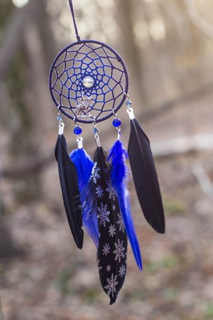 Red black and purple Dreamcatcher with bat made of feathers leather beads and ropes, hangingの写真素材