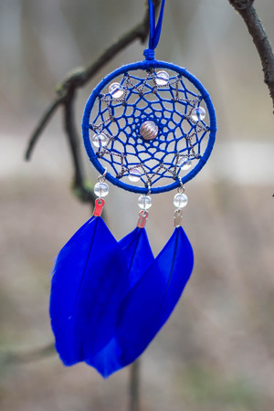Red black and purple Dreamcatcher with bat made of feathers leather beads and ropes, hangingの写真素材