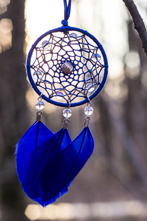 Red black and purple Dreamcatcher with bat made of feathers leather beads and ropes, hangingの写真素材