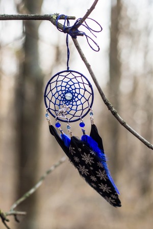 Red black and purple Dreamcatcher with bat made of feathers leather beads and ropes, hangingの写真素材