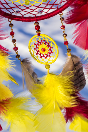 Red black and purple Dreamcatcher with bat made of feathers leather beads and ropes, hangingの写真素材