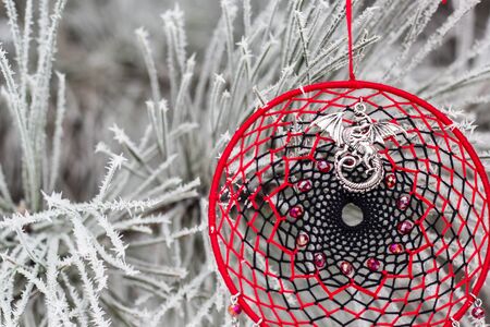 Red black and purple Dreamcatcher with bat made of feathers leather beads and ropes, hangingの写真素材