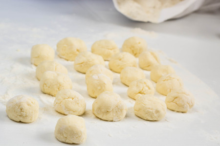 Raw dumplings with cottage cheese on the tableの写真素材