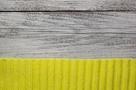 Close-up yellow fabric textile texture on white wooden backgroundの写真素材