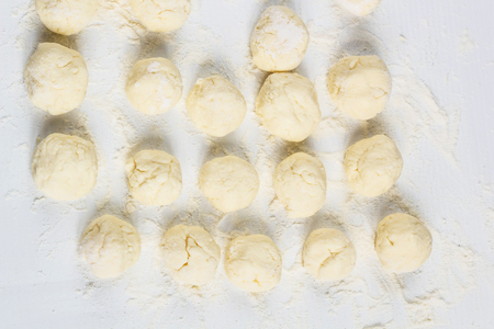 Raw dumplings with cottage cheese on the tableの写真素材