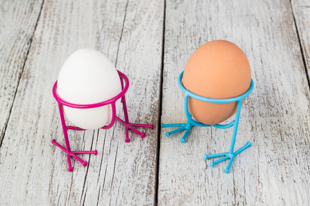 Easter. Orange and white eggs in the egg rack in the form of chicken legs.の写真素材
