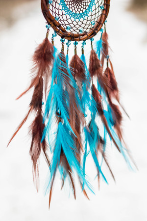 Dreamcatcher made of feathers, leather, beads, and ropesの写真素材