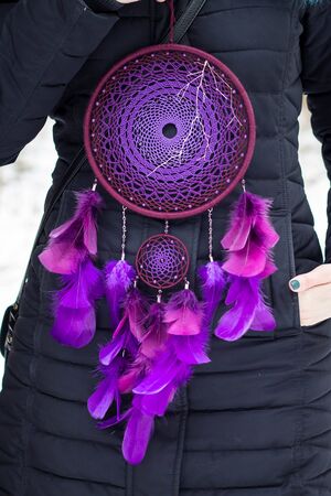 Red black and purple Dreamcatcher with bat made of feathers leather beads and ropes, hangingの写真素材