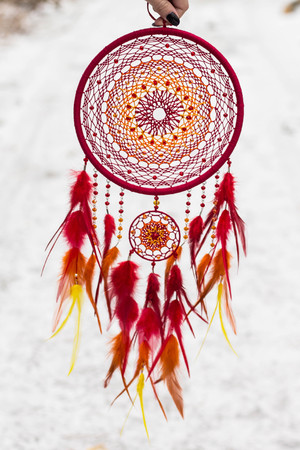 Dreamcatcher made of feathers, leather, beads, and ropesの写真素材