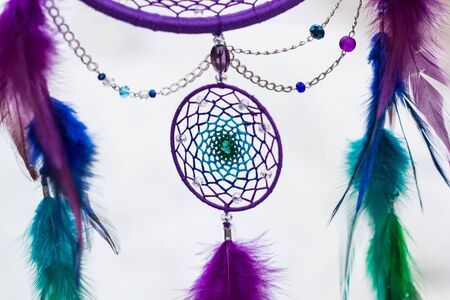 Green purple and blue Dreamcatcher made of feathers leather beads and ropes, hangingの写真素材