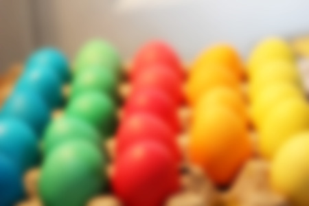 Many brightly colored Easter eggs. Blurred celebratory background holiday