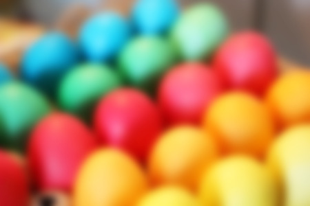 Many brightly colored Easter eggs. Blurred celebratory background holidayの写真素材