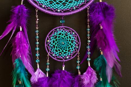 Colorful Dreamcatcher made of feathers leather beads and ropes, hanging, handmadeの写真素材