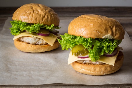 Close-up of home made tasty burgers on wooden table.の写真素材
