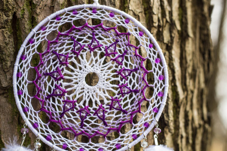 Red black and purple Dreamcatcher with bat made of feathers leather beads and ropes, hangingの写真素材