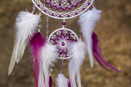 Red black and purple Dreamcatcher with bat made of feathers leather beads and ropes, hangingの写真素材