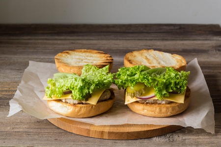 Close-up of home made tasty burgers on wooden table.の写真素材